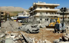 A bulldozer clears debris near heavily damaged buildings in the village of Bednayel in Lebanon's eastern Bekaa Valley region on February 21, 2026, following Israeli strikes. (AFP)