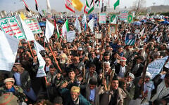 Armed Yemeni supporters of the Iran-backed Houthi movement brandish their weapons during a protest against US strikes on Iran in Sanaa on July 10, 2026. (Mohammed HUWAIS/AFP)