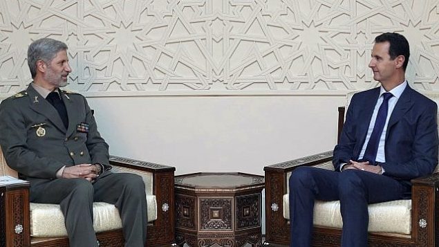 تصویر: عکسی که در خبرگزاری رسمی سوریه، سانا، منتشر شده بشار اسد رئیس جمهور سوریه (راست) را در ملاقات با امیر حاتمی وزیر دفاع ایران در دمشق، سوریه، نشان می دهد، ۲۶ اوت ۲۰۱۸. (SANA via AP) تصویر: عکسی که در خبرگزاری رسمی سوریه، سانا، منتشر شده بشار اسد رئیس جمهور سوریه (راست) را در ملاقات با امیر حاتمی وزیر دفاع ایران در دمشق، سوریه، نشان می دهد، ۲۶ اوت ۲۰۱۸. (SANA via AP)