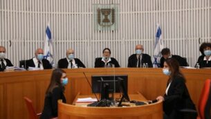 Judges and personnel of the Israeli Supreme Court wearing face masks against the coronavirus Covid-19, attend a session on May 4, 2020 at the Supreme Court in Jerusalem. - The Court tackled the vexed question of whether a political deal to form a coalition government after three inconclusive elections in less than a year is actually legal. A ruling against the pact could leave the country facing a fourth poll. Under the proposed three-year agreement between Prime Minister Benjamin Netanyahu and his rival-turned-partner Benny Gantz, each would head the government for a period of 18 months. (Photo by ABIR SULTAN / POOL / AFP)