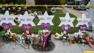 TREE OF LIFE SYNAGOGUE, PITTSBURGH, PENNSYLVANIA, UNITED STATES - 2018/10/29: Flowers and stones are placed on the memorials erected outside of the Tree of Life Synagogue in Squirrel Hill. Members of Pittsburgh and the Squirrel Hill community pay their respects at the memorial to the 11 victims of the Tree of Life Synagogue massacre perpetrated by suspect Robert Bowers on Saturday, October 27. (Photo by Matthew Hatcher/SOPA Images/LightRocket via Getty Images)