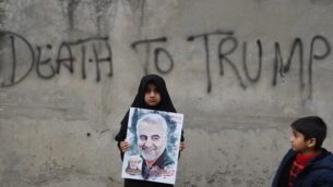 A Shiite Muslim girl holds a poster of Iranian commander Qasem Soleimani as she takes part in a anti-US protest against the killing of top Iranian commander Qasem Soleimani in Iraq, in Lahore on January 12, 2020. - Iran's Revolutionary Guards chief briefed parliament on January 12 over the killing of a top general by the US, Tehran's retaliation and the subsequent downing of an airliner, ISNA news agency said. (Photo by ARIF ALI / AFP)