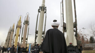 An Iranian cleric looks at domestically built surface-to-surface missiles at a military show marking  the 40th anniversary of Iran's Islamic Revolution that toppled the U.S.-backed shah, at Imam Khomeini Grand Mosque, in Tehran, Iran, Sunday, Feb. 3, 2019.  Since 1992, Iran has developed a self-sufficient military weapons program, producing mortars to missiles. (AP Photo/Vahid Salemi)