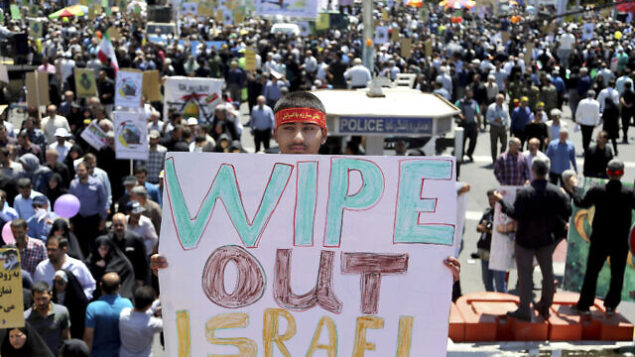 An Iranian protester holds an anti-Israeli placard during an annual anti-Israeli Al-Quds, Jerusalem, Day rally in Tehran, Iran, Friday, June 8, 2018. Iranians attended the rallies across the country to condemn Israeli occupation of Palestinian territories. (AP Photo/Ebrahim Noroozi)