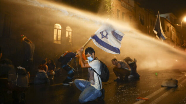 Israeli police uses water canon to disperse people during a protest against Israeli Prime Minister Benjamin Netanyahu In Jerusalem Saturday, July 18, 2020. Protesters demanded that the embattled Israeli leader to resign as he faces a trial on corruption charges and grapples with a deepening coronavirus crisis. (AP Photo/Oded Balilty) Israeli police uses water canon to disperse people during a protest against Israeli Prime Minister Benjamin Netanyahu In Jerusalem Saturday, July 18, 2020. Protesters demanded that the embattled Israeli leader to resign as he faces a trial on corruption charges and grapples with a deepening coronavirus crisis. (AP Photo/Oded Balilty)