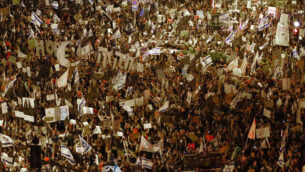 Thousands protest against Israel's Prime Minister Benjamin Netanyahu in front of his official residence in Jerusalem, Saturday, Aug. 8, 2020.  (AP Photo/Ariel Schalit)