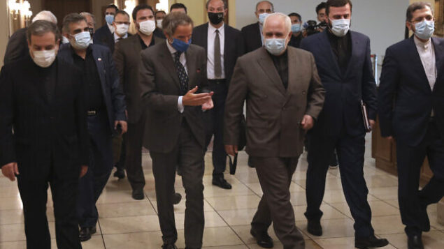 Director General of International Atomic Energy Agency, IAEA, Rafael Mariano Grossi, center left, speaks with Iran's Foreign Minister Mohammad Javad Zarif, center left, before a meeting in Tehran, Iran, Tuesday, Aug. 25, 2020. Grossi arrived in Iran on Monday to press for access to sites where authorities are thought to have stored or used undeclared nuclear material. (AP Photo/Vahid Salemi) Director General of International Atomic Energy Agency, IAEA, Rafael Mariano Grossi, center left, speaks with Iran's Foreign Minister Mohammad Javad Zarif, center left, before a meeting in Tehran, Iran, Tuesday, Aug. 25, 2020. Grossi arrived in Iran on Monday to press for access to sites where authorities are thought to have stored or used undeclared nuclear material. (AP Photo/Vahid Salemi)