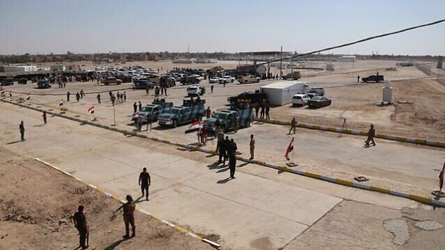 Iraqi security forces prepare to open the crossing between the Iraqi town of Qaim and Syria's Boukamal, in Qaim, Iraq, Monday, Sept. 30, 2019. Iraq and Syria opened Monday a key border crossing between the two neighboring countries, seven years after it was closed during Syria's civil war and the battle against the Islamic State group. (AP Photo/Hadi Mizban)
