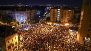 Thousands of protesters chant slogans and hold signs during a protest against Israel's Prime Minister Benjamin Netanyahu outside his residence in Jerusalem, Saturday, Aug 1, 2020. Protesters demanded that the embattled Israeli leader to resign as he faces a trial on corruption charges and grapples with a deepening coronavirus crisis. (AP Photo/Oded Balilty)