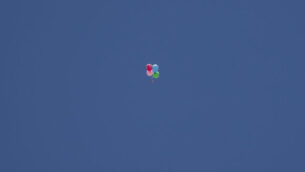Balloons carrying an incendiary device launched from the Gaza Strip drift to the Israeli side of the border between Gaza and Israel, Monday, Aug. 24, 2020. Militants affiliated with Hamas have launched scores of incendiary balloons into southern Israel in recent weeks in a bid to pressure Israel to ease the blockade imposed since Hamas took control of the territory in 2007. (AP Photo/Ariel Schalit)