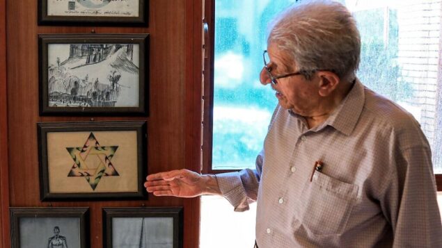 Omar Farhadi, an elderly Iraqi Kurd points to a frame showing a stylized hexagram, or a Star of David, hanging in a room dedicated to famous Jewish Kurdish art teacher and painter Daniel Kassab, at the Museum of Education in Arbil's oldest primary school, in the capital of the autonomous Kurdish region of northern Iraq, on July 5, 2020. - Jews were historically Iraq's second-largest religious sect, comprising 40 percent of Baghdad's population according to a 1917 census. But since the creation of Israel in 1948, regional tensions skyrocketed and anti-Semitic campaigns took hold, pushing most of Iraq's Jews to flee. Today, Iraqis have fond memories of Jewish friends and neighbours, including 82-year-old Farhadi, whose father owned a shop in a Jewish-majority district of Arbil. (Photo by SAFIN HAMED / AFP) Omar Farhadi, an elderly Iraqi Kurd points to a frame showing a stylized hexagram, or a Star of David, hanging in a room dedicated to famous Jewish Kurdish art teacher and painter Daniel Kassab, at the Museum of Education in Arbil's oldest primary school, in the capital of the autonomous Kurdish region of northern Iraq, on July 5, 2020. - Jews were historically Iraq's second-largest religious sect, comprising 40 percent of Baghdad's population according to a 1917 census. But since the creation of Israel in 1948, regional tensions skyrocketed and anti-Semitic campaigns took hold, pushing most of Iraq's Jews to flee. Today, Iraqis have fond memories of Jewish friends and neighbours, including 82-year-old Farhadi, whose father owned a shop in a Jewish-majority district of Arbil. (Photo by SAFIN HAMED / AFP)