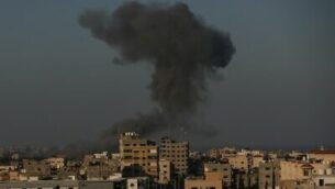 Smoke rises in the distance after war planes belonging to the Israeli army carried out airstrikes over Gaza City on August 28, 2020. (Photo by MAHMUD HAMS / AFP)