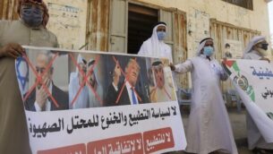 Palestinian men carry the exed out portraits of the Bahraini King, US President and Israeli Premier during a protest in Deir al-Balah, in central Gaza Strip, on September 12, 2020, to condemn the normalisation of ties between Israeli and Bahrain. - The Palestinian cause has long cemented ties between Middle East nations with divergent interests, but amid shifting regional alliances they are increasingly isolated and in need of new friends, analysts say. In the latest blow, Bahrain broke ranks and agreed on Friday to open diplomatic ties with Israel, in a deal announced in Washington by President Donald Trump. (Photo by MAHMUD HAMS / AFP)