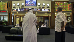 Emirati and other traders discuss the latest news at the Dubai Financial Market in Dubai, United Arab Emirates, Tuesday Aug. 9, 2011.  Europe's top central banker, European Central Bank Chairman Jean-Claude Trichet, says the bank's "unconventional" moves to buy eurozone government bonds are aimed at restoring confidence to a financial system shaken by the worst crisis since World War II.(AP Photo/Kamran Jebreili)