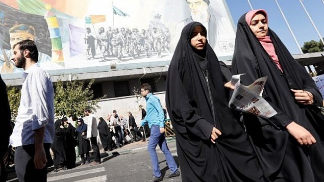 چند زن ایرانی ، پس از نماز جمعه، حین عبور از خیابانی در تهران، با تصویری از ولی فقیه پیشین آیتالله روحالله خمینی در زمینهی عکس – ۱۳ اکتبر ۲۰۱۷ چند زن ایرانی ، پس از نماز جمعه، حین عبور از خیابانی در تهران، با تصویری از ولی فقیه پیشین آیتالله روحالله خمینی در زمینهی عکس – ۱۳ اکتبر ۲۰۱۷