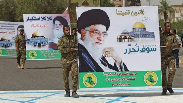 تصویر: شبه نظامیان شیعه با پوستر ولی فقیه ایران آیت الله علی خامنه ای و لگد کردن تصویری از پرچم اسرائیل در راهپیمایی روز قدس در بغداد پایتخت عراق، ۸ ژوئن ۲۰۱۸. (AFP Photo/Ahmad Al-Rubaye) تصویر: شبه نظامیان شیعه با پوستر ولی فقیه ایران آیت الله علی خامنه ای و لگد کردن تصویری از پرچم اسرائیل در راهپیمایی روز قدس در بغداد پایتخت عراق، ۸ ژوئن ۲۰۱۸. (AFP Photo/Ahmad Al-Rubaye)