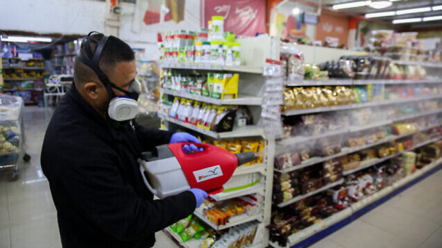 Workers disinfect Bar Kol Supermarket in the northern Israeli city of Tzfat, on March 16, 2020, as part of measures to prevent the spread of the Coronavirus. Photo by David Cohen/Flash90 *** Local Caption *** קורונה
וירוס
בר כל
סופרמרקט
עובדים
בניין
חיטוי Workers disinfect Bar Kol Supermarket in the northern Israeli city of Tzfat, on March 16, 2020, as part of measures to prevent the spread of the Coronavirus. Photo by David Cohen/Flash90 *** Local Caption *** קורונה
וירוס
בר כל
סופרמרקט
עובדים
בניין
חיטוי