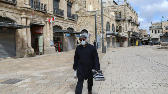 A man wearing a face mask for fear of the coronavirus walks near by the Jaffa Gate in the Old City of Jerusalem on March 21, 2020. Israel's government approved additional measures to limit movement of citizens and banning gatherings of over 10 people to contain the covid 19 virus pandemic.
Photo by Yossi Zamir/Flash90 *** Local Caption *** ?????
??????
????
???
??????? A man wearing a face mask for fear of the coronavirus walks near by the Jaffa Gate in the Old City of Jerusalem on March 21, 2020. Israel's government approved additional measures to limit movement of citizens and banning gatherings of over 10 people to contain the covid 19 virus pandemic.
Photo by Yossi Zamir/Flash90 *** Local Caption *** ?????
??????
????
???
???????
