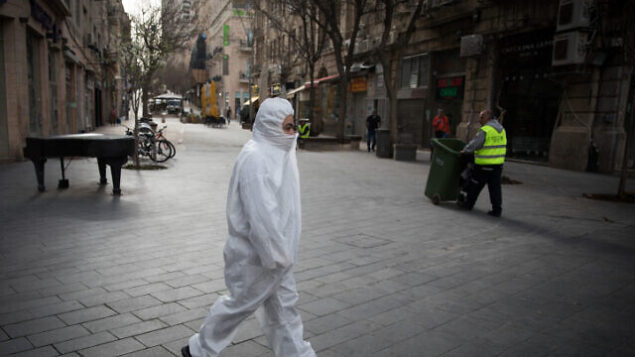 A man wearing protective clothes for fear of the coronavirus walks in Jaffa street in downtown Jerusalem on March 20, 2020. Photo by Nati Shohat/Flash90 *** Local Caption *** ????
????
??????
?????
??????
?????
???? ??? A man wearing protective clothes for fear of the coronavirus walks in Jaffa street in downtown Jerusalem on March 20, 2020. Photo by Nati Shohat/Flash90 *** Local Caption *** ????
????
??????
?????
??????
?????
???? ???