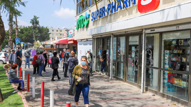 People wear protective face masks as they walk in Lod on April 12, 2020. The government ordered on a partial lockdown, in order to prevent the spread of the Coronavirus
Photo by Yossi Aloni/Flash90 *** Local Caption ***