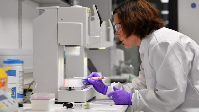 Volunteer scientists process samples taken from people tested for the novel coronavirus, at a laboratory recently dedicated for the processing of COVID-19 samples by Medicines Discovery Catapult, at The Lighthouse Lab at Alderley Park in Cheshire, northern England, on April 22, 2020. - The laboratory is one of a number of new facilities opened in recent days for the testing of samples taken from people displaying symptoms of the novel coronavirus. (Photo by Paul ELLIS / AFP)