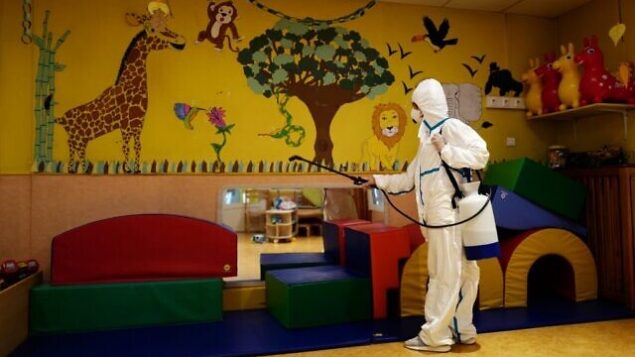 A member of a desinfection squad cleans a nursery in the French Riviera city of Cannes, southern France, on May 6, 2020, as the nurseries in France are to gradually reopen from May 11, when a partial lifting of restrictions due to the Covid-19 pandemic caused by the novel coronavirus comes into effect. (Photo by VALERY HACHE / AFP) A member of a desinfection squad cleans a nursery in the French Riviera city of Cannes, southern France, on May 6, 2020, as the nurseries in France are to gradually reopen from May 11, when a partial lifting of restrictions due to the Covid-19 pandemic caused by the novel coronavirus comes into effect. (Photo by VALERY HACHE / AFP)