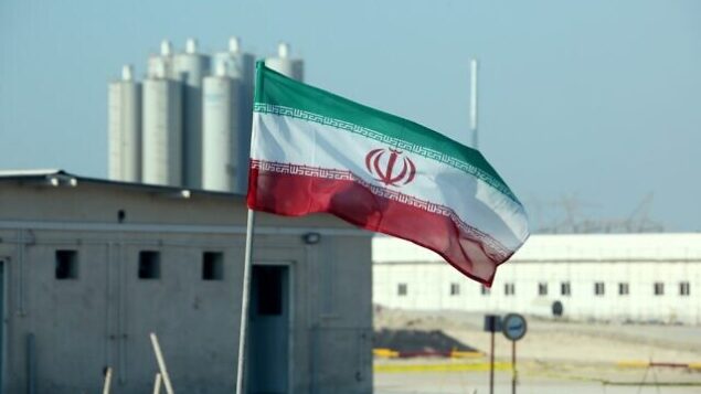 (FILES) In this file photo taken on November 10, 2019 an Iranian flag flutters in Iran's Bushehr nuclear power plant, during an official ceremony to kick-start works on a second reactor at the facility. - A magnitude 4.5 earthquake on Januray 8, 2020 rattled an area less than 50 kilometres (30 miles) from Iran's Bushehr nuclear power plant near the country's Gulf coast, a US monitor said. The quake, which had a depth of 10 kilometres, struck 17 kilometres south-southeast of Borazjan city at 6:49 am (0319 GMT), the US Geological Survey said on its website. State news agency IRNA said the earthquake was felt in Bushehr, site of the country's sole nuclear power plant. (Photo by ATTA KENARE / AFP)