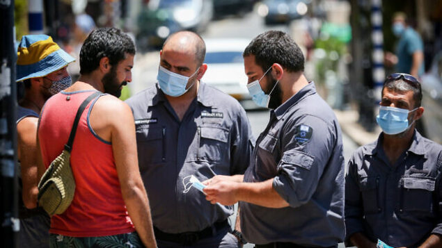 Inspectors talk to people who are not wearing face mask in the northern Israeli city of Tzfat, June 15, 2020. Photo by David Cohen/Flash90 *** Local Caption *** קורונה
מסכה
צפת
פקחים Inspectors talk to people who are not wearing face mask in the northern Israeli city of Tzfat, June 15, 2020. Photo by David Cohen/Flash90 *** Local Caption *** קורונה
מסכה
צפת
פקחים
