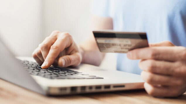 Young man shopping with credit card and laptop computer Young man shopping with credit card and laptop computer