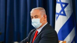 Israeli Prime Minister Benjamin Netanyahu, wearing a protective face mask, chairs the weekly cabinet meeting in Jerusalem on May 31, 2020. (Photo by RONEN ZVULUN / POOL / AFP)