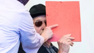 93-year-old former SS guard Bruno Dey in the concentration camp Stutthof near Danzig, arrives at the regional court in Hamburg, Germany, Monday, Oct. 21, 2019. The prosecution accuses the 93-year-old man of aiding and abetting the murder of 5230 people. (Daniel Bockwoldt/dpa via AP)