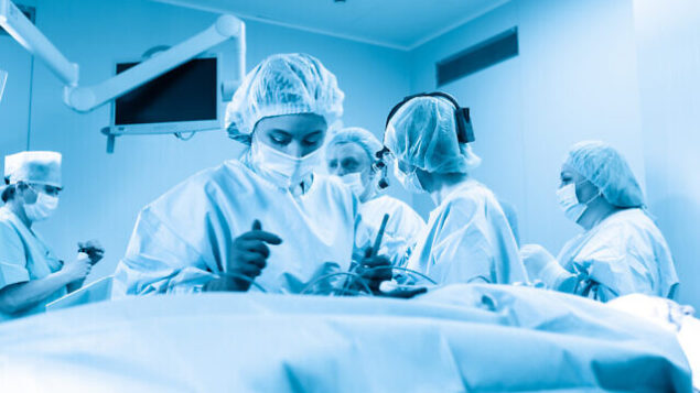 Intensive care, saving the patient s life. Doctors do everything possible to save a person from pneumonia of the virus covid 19. Epidemic, blue filter. Intensive care, saving the patient s life. Doctors do everything possible to save a person from pneumonia of the virus covid 19. Epidemic, blue filter.