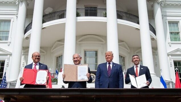 (L-R)Bahrain Foreign Minister Abdullatif al-Zayani, Israeli Prime Minister Benjamin Netanyahu, US President Donald Trump, and UAE Foreign Minister Abdullah bin Zayed Al-Nahyan hold up documents after participating in the signing of the Abraham Accords where the countries of Bahrain and the United Arab Emirates recognize Israel, at the White House in Washington, DC, September 15, 2020. - Israeli Prime Minister Benjamin Netanyahu and the foreign ministers of Bahrain and the United Arab Emirates arrived September 15, 2020 at the White House to sign historic accords normalizing ties between the Jewish and Arab states. (Photo by SAUL LOEB / AFP)