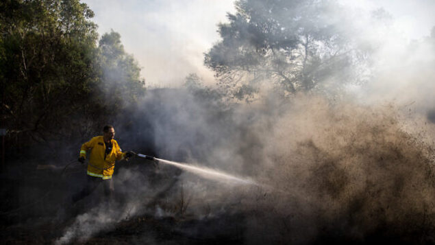 A firefighters attempts to extinguish a fire started by an incendiary device launched from the Gaza Strip, in Kibbutz Kfar Aza on the border with Gaza, Monday, Aug. 24, 2020. Militants affiliated with Hamas have launched scores of incendiary balloons into southern Israel in recent weeks in a bid to pressure Israel to ease the blockade imposed since Hamas took control of the territory in 2007. (AP Photo/Ariel Schalit) A firefighters attempts to extinguish a fire started by an incendiary device launched from the Gaza Strip, in Kibbutz Kfar Aza on the border with Gaza, Monday, Aug. 24, 2020. Militants affiliated with Hamas have launched scores of incendiary balloons into southern Israel in recent weeks in a bid to pressure Israel to ease the blockade imposed since Hamas took control of the territory in 2007. (AP Photo/Ariel Schalit)