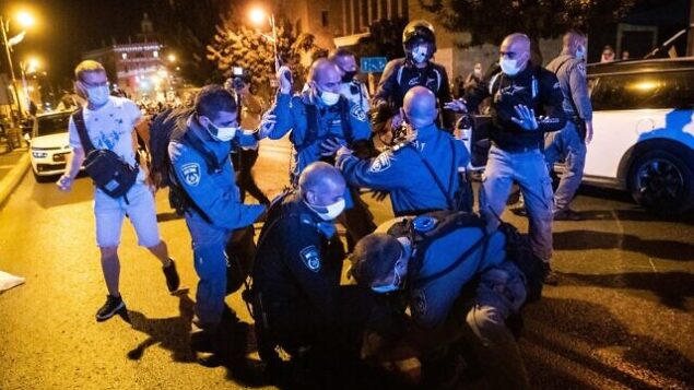 Police officers arrest a man who allegedly tried to run over protesters during a protest against Israeli prime minister Benjamin Netanyahu, outside PM Netanyahu's official residence in Jerusalem on September 20, 2020. Photo by Yonatan Sindel/Flash90 *** Local Caption ***