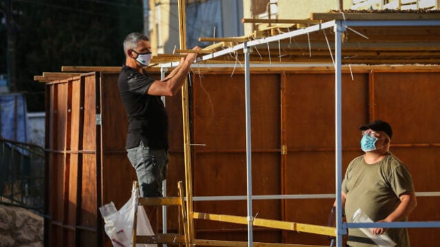 Jews building a "Sukka" for the upcoming Jewish holiday of Sukkot, in the streets of the northern Israeli city of Tzfat, September 29, 2020. Photo by David Cohen/Flash90 *** Local Caption *** Jews building a "Sukka" for the upcoming Jewish holiday of Sukkot, in the streets of the northern Israeli city of Tzfat, September 29, 2020. Photo by David Cohen/Flash90 *** Local Caption ***