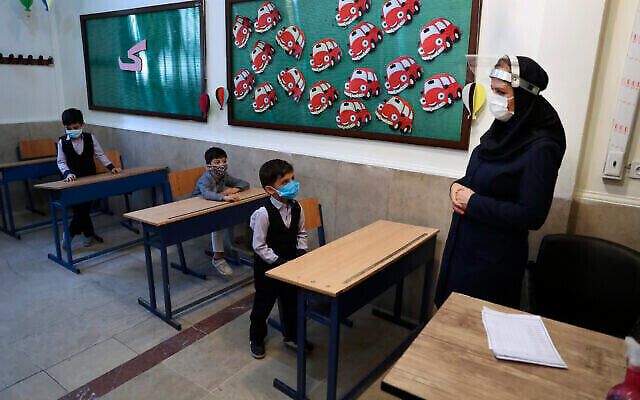 تصویر: دانش آموزان و آموزگارشان در کلاس درس، پس از مراسم گشایش مدرسه هشترودی در تهران، ایران، ۵ سپتامبر ۲۰۲۰. (AP Photo/Vahid Salemi)