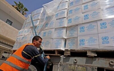 A truck loaded with humanitarian aid, passes into Rafah in the southern Gaza Strip, through the Kerem Shalom crossing, the main passage point for goods entering Gaza from Israel, on May 21, 2021, after a ceasefire brokered by Egypt between Israel and the Palestinian Hamas movement. - A ceasefire between Israel and Hamas, the Islamist movement which controls the Gaza Strip, appeared to hold today after 11 days of deadly fighting that pounded the Palestinian enclave and forced countless Israelis to seek shelter from rockets. (Photo by SAID KHATIB / AFP)