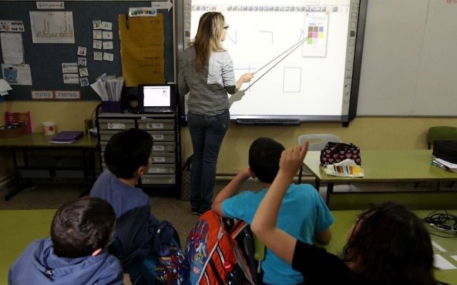 A teacher uses a touch-screen 'smart board' in a Jerusalem classroom. (photo credit: Kobi Gideon/Flash90)