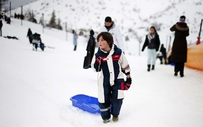 Des enfants faisant de la luge à la station de ski du mont Hermon (Crédit : Dima Vazinovich/Flash90)