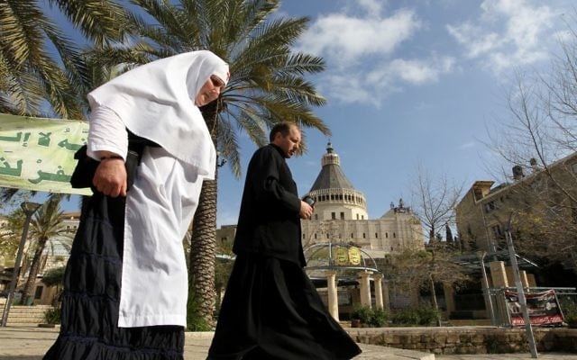 Une nonne et un prêtre devant la Basilique de l'Annonciation de Nazareth. Illustration. (Crédit : Nati Shohat/Flash90)