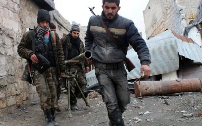 Des rebelles syriens transportent un lance-roquettes lors de combats contre l'armée, le 27 janvier 2014 à Alep
(Crédit : AFP/Salah Al-Ashkar) Des rebelles syriens transportent un lance-roquettes lors de combats contre l'armée, le 27 janvier 2014 à Alep
(Crédit : AFP/Salah Al-Ashkar)