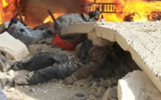Le corps d'un homme coincé sous les gravats, sur le site d'une attaque à la bombe à Alep le 21 janvier 2014  (Crédit : AFP/Archives Mahmud Al-Halabi)