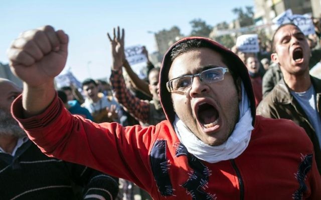 Manifestants égyptiens au Caire, le 25 janvier 2014. (Crédit : Mahmoud Khaled/AFP) Manifestants égyptiens au Caire, le 25 janvier 2014. (Crédit : Mahmoud Khaled/AFP)
