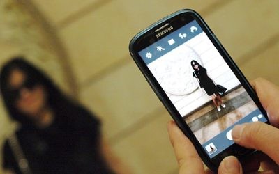 Personne prenant une photo avec son téléphone (Crédit : Wikimedia Commons/CC BY-SA 3.0/Petar Milošević)