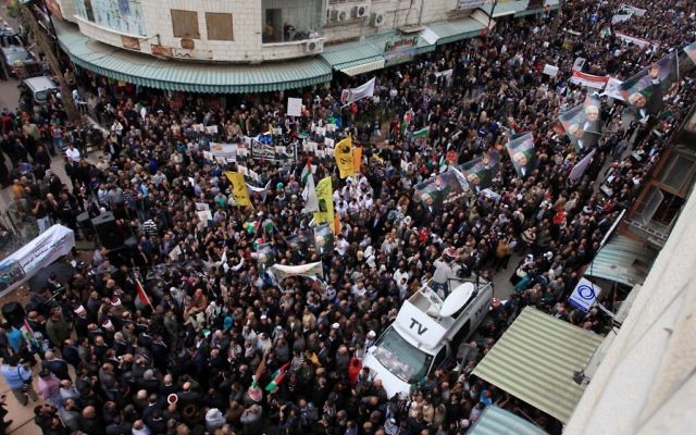 Des partisans du Fatah manifestent leur soutien au président de l’Autorité palestinienne, Mahmoud Abbas, dans les rues de Ramallah, le 17 mars 2014 (Crédit : Issam Rimawi/FLASH90)