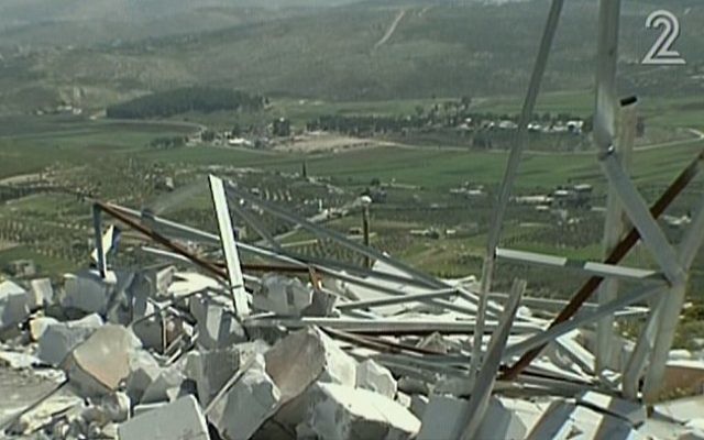 Les restes d'un poste de contrôle de l'armée israélienne, détruit par les habitants de Yitzhar, avril 2014 (Crédit : capture d'écran/Deuxième Chaîne)