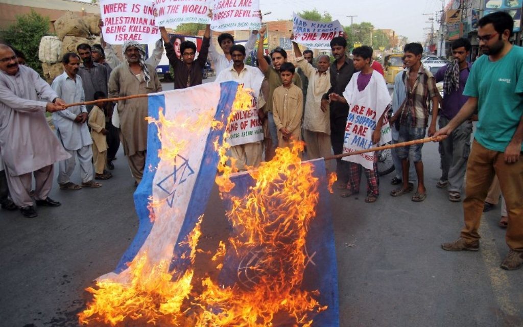 Manifestants pakistanais qui brûlent des drapeaux israéliens et les drapeaux des Nations Unies lors d'une manifestation contre les opérations militaires israéliennes dans la bande de Gaza - Multan, le 22 juillet 2014 (Crédit : AFP PHOTO / SS MIRZA)