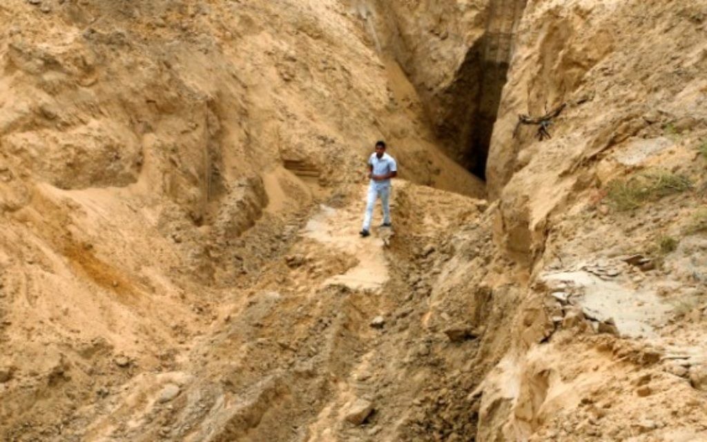 Un Palestinien se penche sur ce qui était autrefois un tunnel menant de la bande de Gaza vers Israël, dans la région de Rafah, dans le sud de la bande de Gaza, le 5 août 2014, après une trêve de 72 heures (Crédit : Abed Rahim Khatib / Flash90)