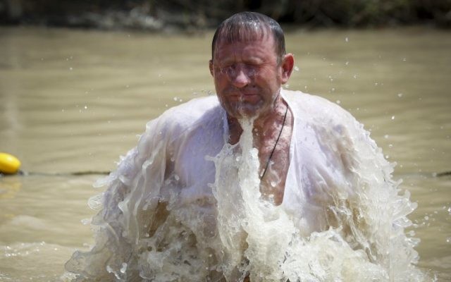Un pèlerin chrétien orthodoxe prend un bain dans le Jourdain, dans le cadre d'une cérémonie de baptême traditionnelle sur le site de Qasr el Yahud, l'endroit où l'on pense que Jésus a été baptisé, près de la ville de Jéricho, en Cisjordanie, le 11 avril 2015. (Crédit : Maxim Dinshtein / Flash90) Un pèlerin chrétien orthodoxe prend un bain dans le Jourdain, dans le cadre d'une cérémonie de baptême traditionnelle sur le site de Qasr el Yahud, l'endroit où l'on pense que Jésus a été baptisé, près de la ville de Jéricho, en Cisjordanie, le 11 avril 2015. (Crédit : Maxim Dinshtein / Flash90)